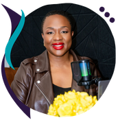 Headshot of Lola Dada-Olley, a woman wearing a brown leather jacket and red lipstick, seated in front of a microphone with yellow flowers visible in the foreground, shown in a circular crop with a teal and purple decorative swoosh graphic element