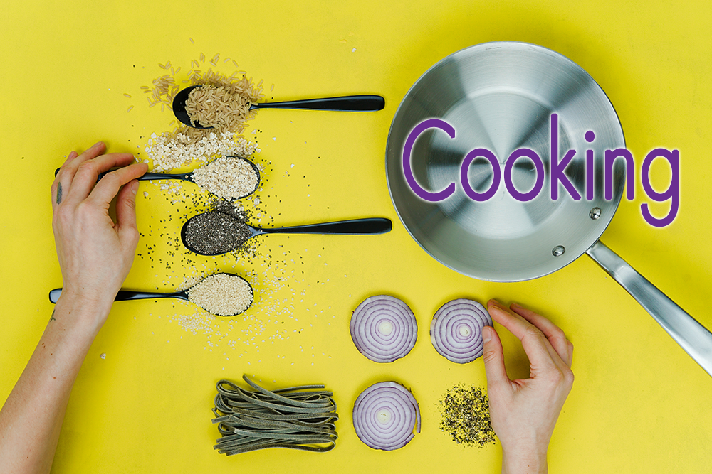 yellow background with 4 spoons filled with spices, a frying pan, sliced onions and other herbs, and the text "cooking"