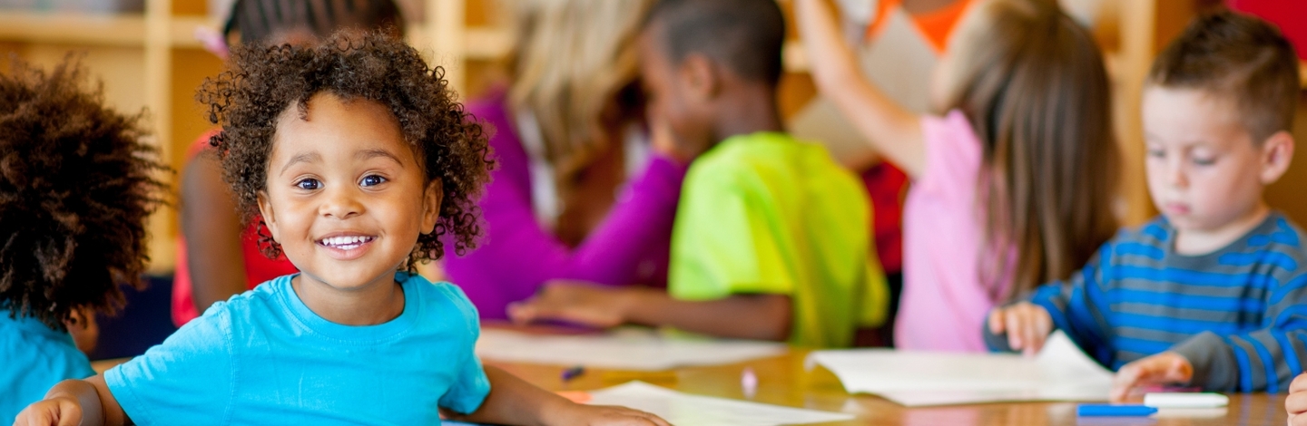 group of children ages 3-5 surrounding small group table